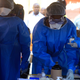 Healthcare workers from the World Health Organization prepare to give an Ebola vaccination to a front line aid worker in the Democratic Republic of Congo earlier this month.